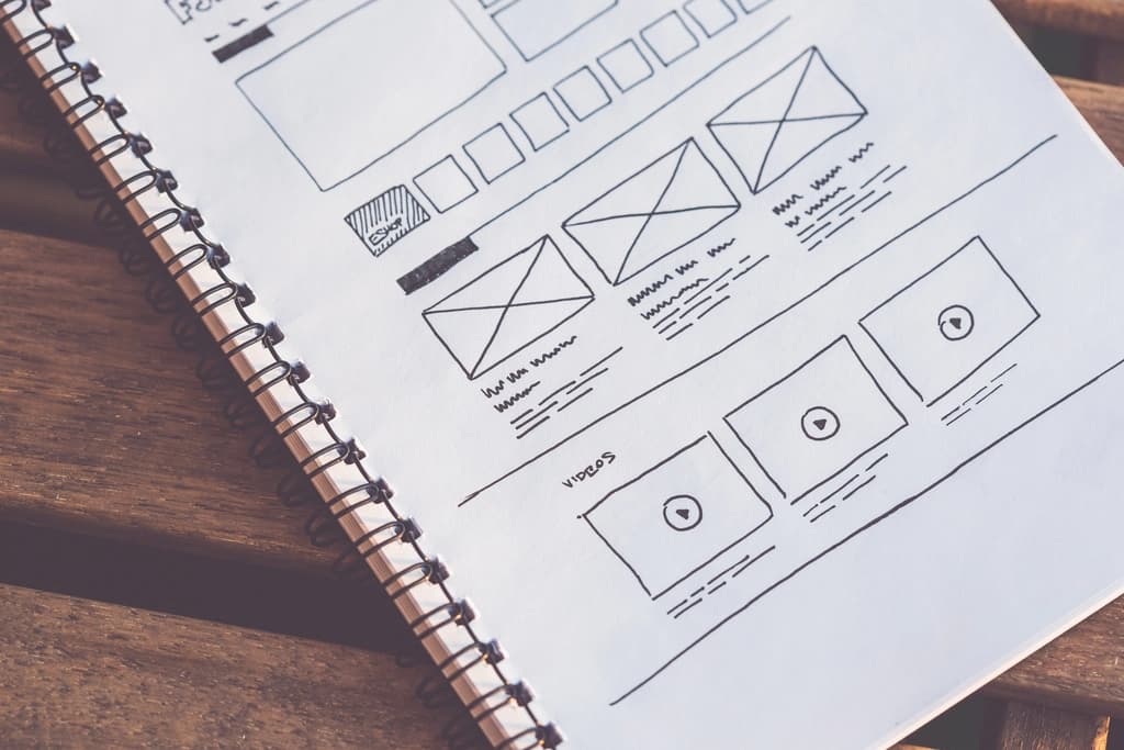 Hand-drawn website wireframes in a notebook